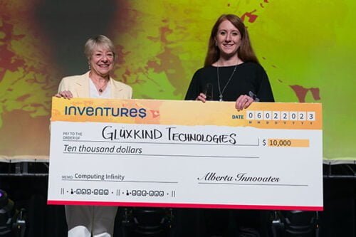 A person receiving a oversized cheque for $10,000